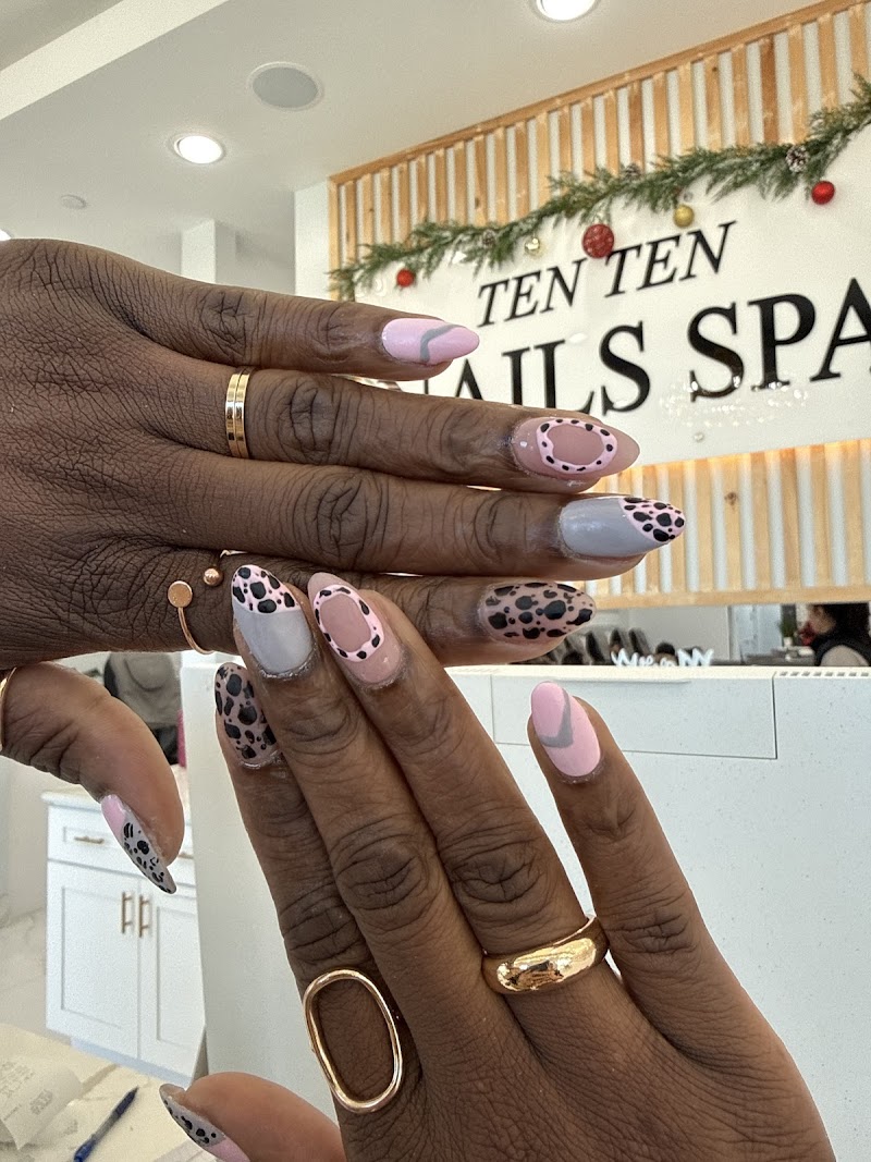 Leopard print nail design with salon sign in background